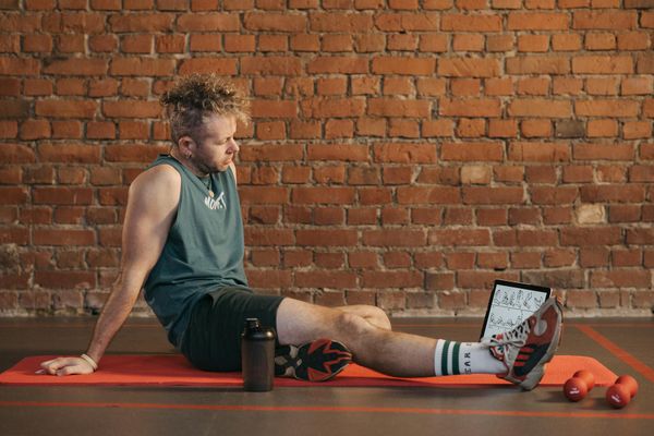 Man stretching outdoors after workout